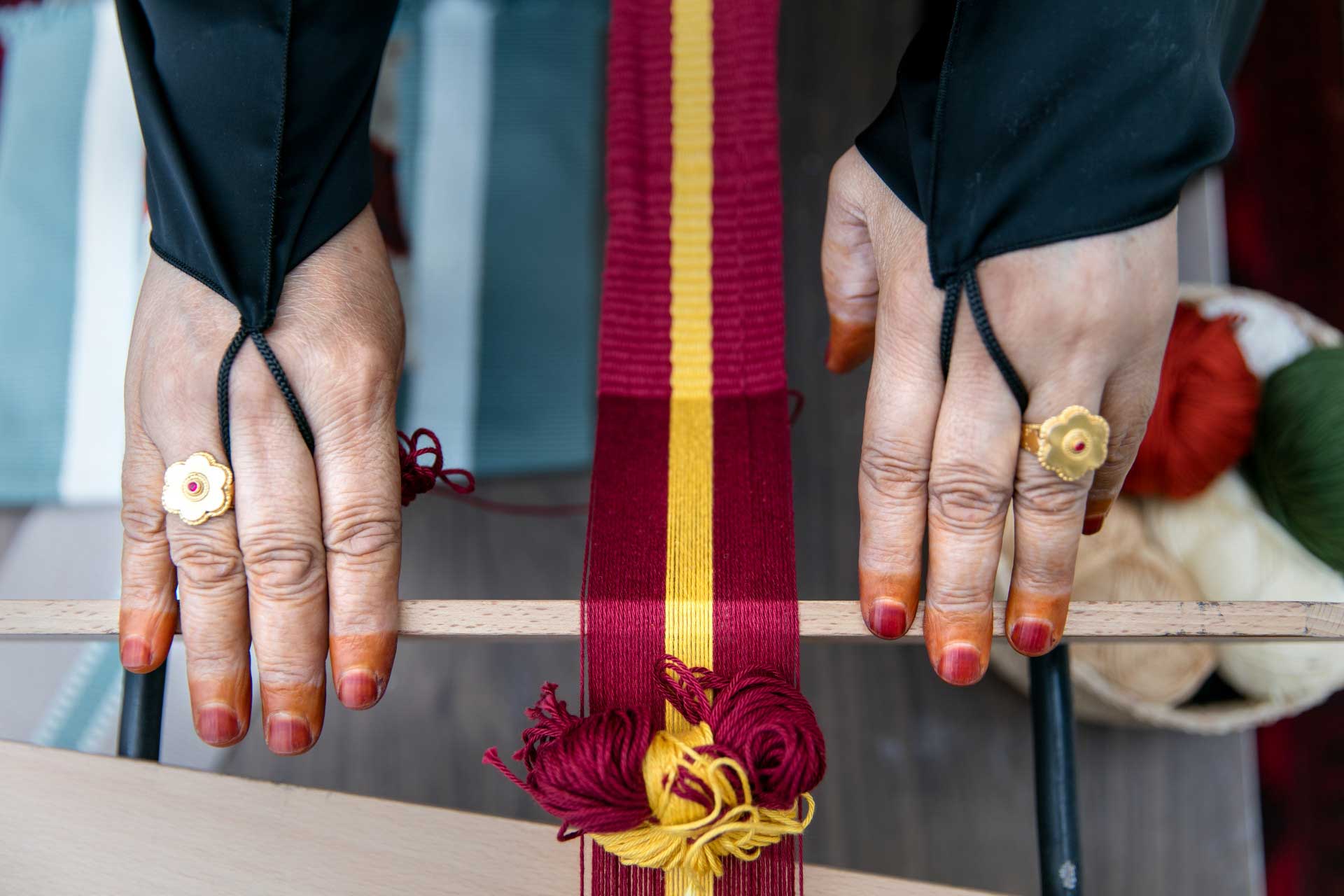 Hands from a woman at the Al Ghadeer UAE Crafts centre